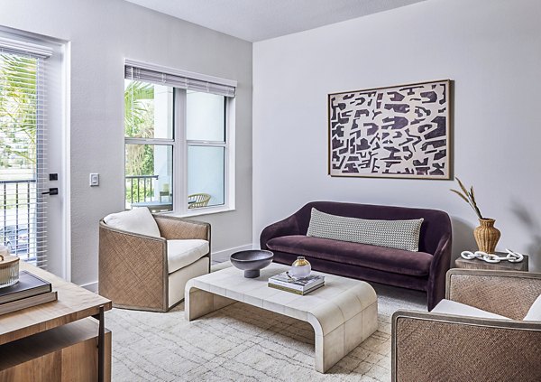 Spacious living room with large windows and contemporary decor in Asbury Apartments at Greystar luxury apartments