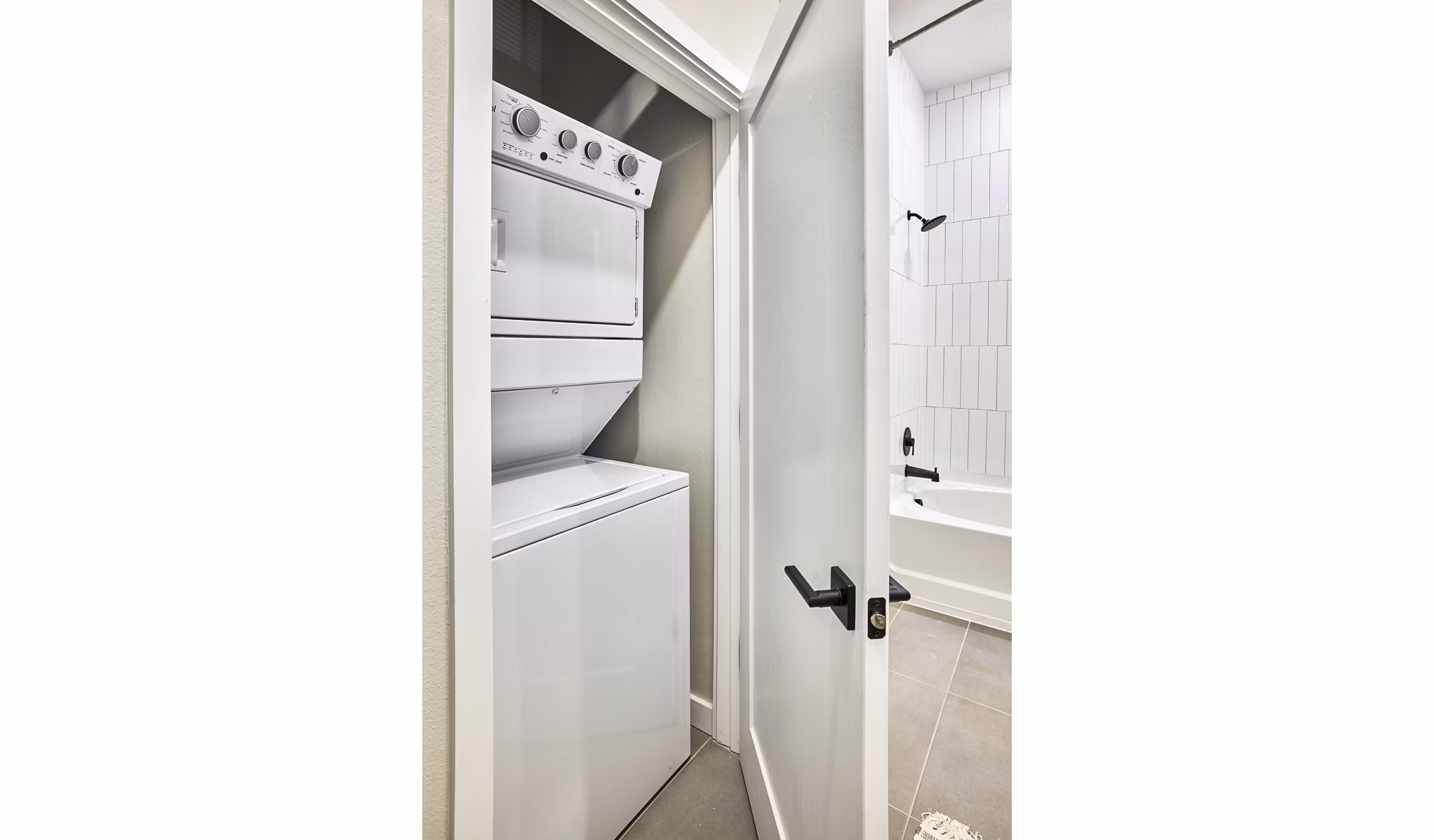 Bath and laundry room featuring modern appliances at Asbury Apartments