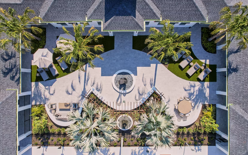 Patio with modern seating and greenery at Asbury Apartments, offering a relaxing outdoor space for luxury living