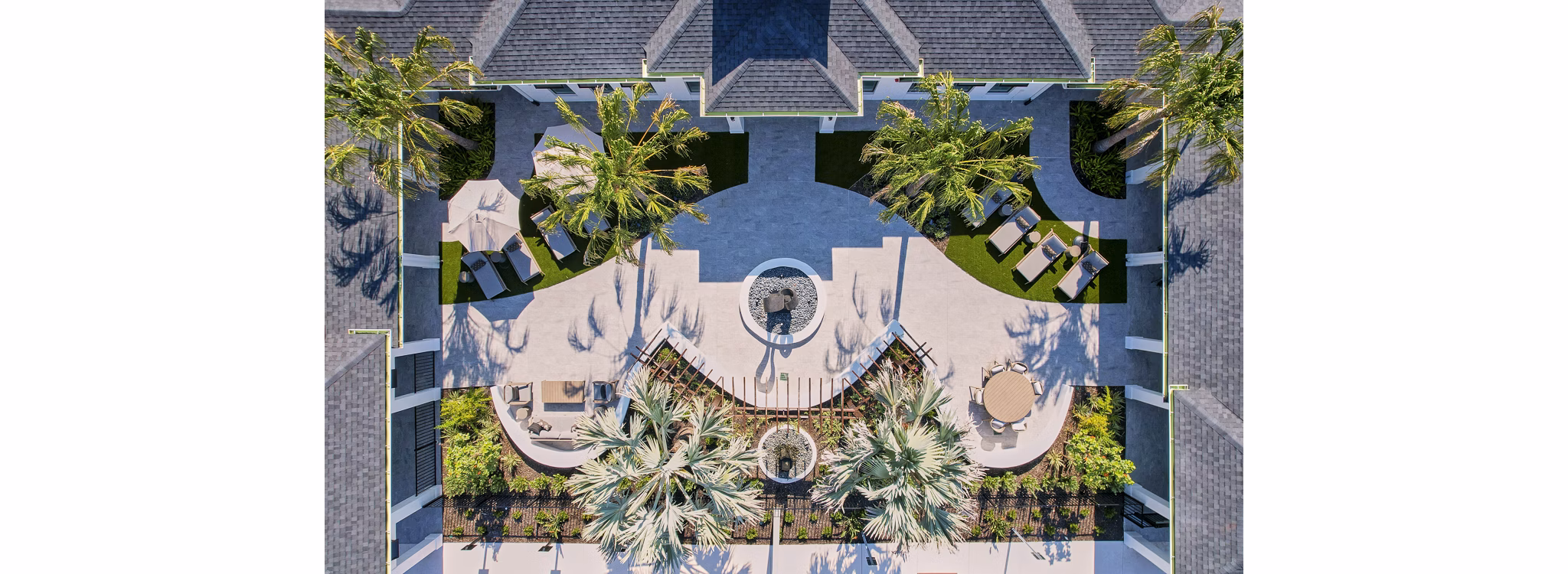 Patio with modern seating and greenery at Asbury Apartments, offering a relaxing outdoor space for luxury living