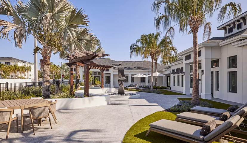 Asbury Apartments: Elegant patio with stylish furnishings and lush greenery