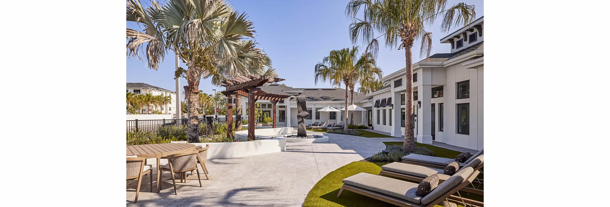 Asbury Apartments: Elegant patio with stylish furnishings and lush greenery