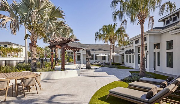 Asbury Apartments: Elegant patio with stylish furnishings and lush greenery