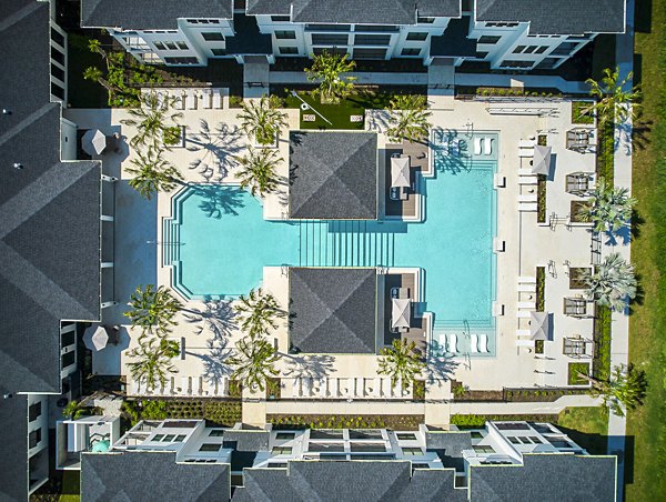 Modern pool with sun loungers at Asbury Apartments, a luxury community by Greystar