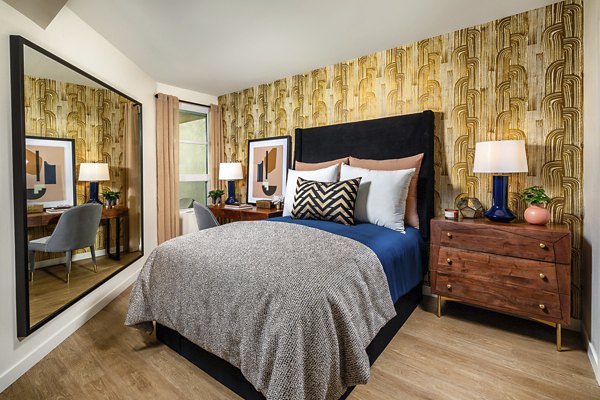 Spacious bedroom with modern dÃ©cor at Rae on Sunset Apartments in a luxurious setting