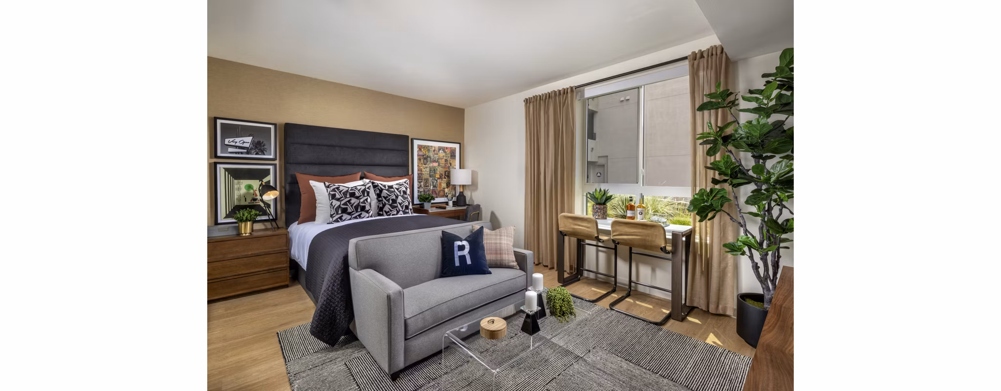 Cozy bedroom with stylish decor at Rae on Sunset Apartments in a Greystar luxury community