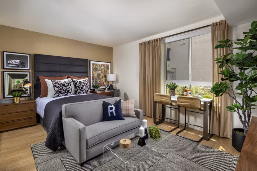 Cozy bedroom with stylish decor at Rae on Sunset Apartments in a Greystar luxury community