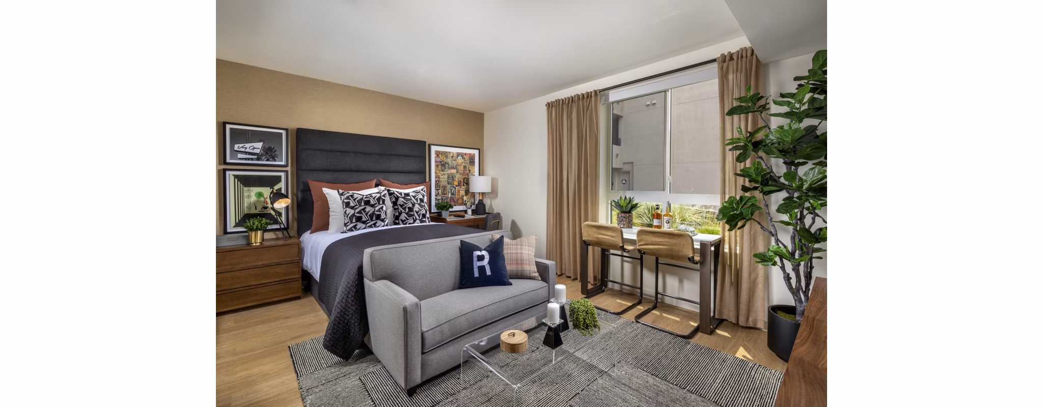 Cozy bedroom with stylish decor at Rae on Sunset Apartments in a Greystar luxury community