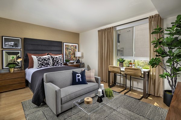 Cozy bedroom with stylish decor at Rae on Sunset Apartments in a Greystar luxury community