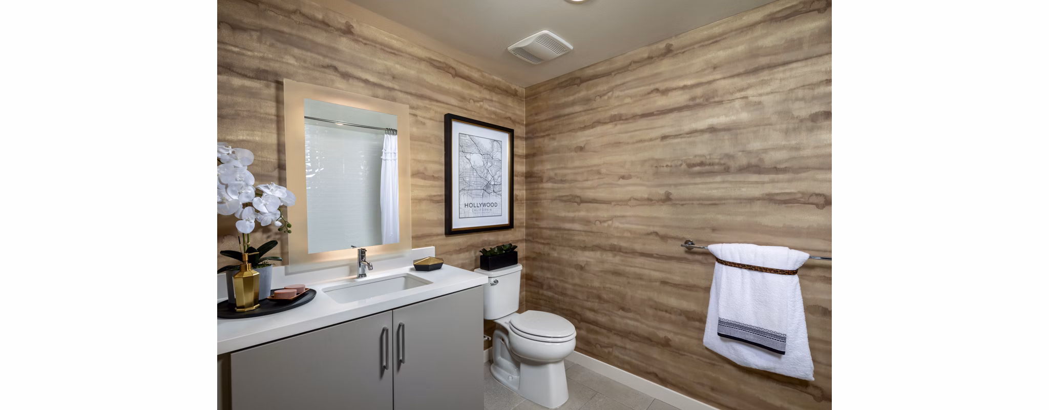 Bathroom with elegant marble countertops and shower at Rae on Sunset Apartments