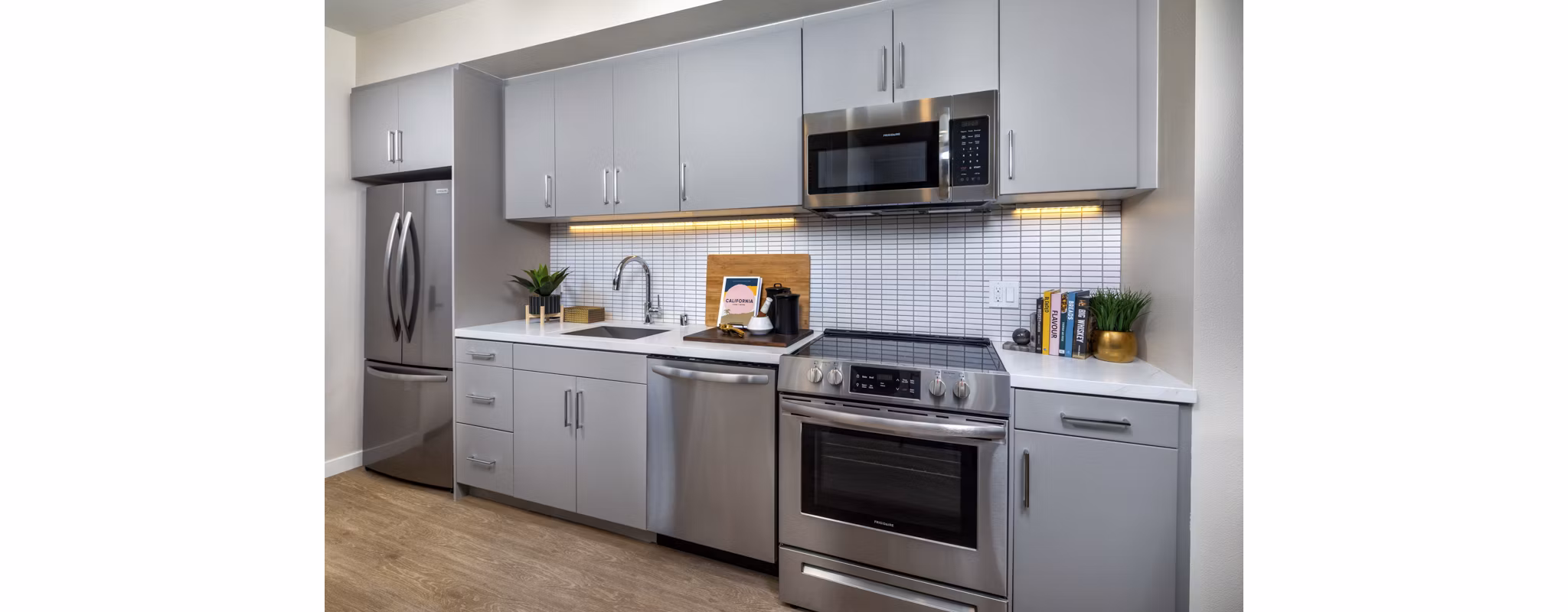Modern kitchen with stainless steel appliances at Rae on Sunset Apartments, luxury living near Greystar's vibrant cityscapes