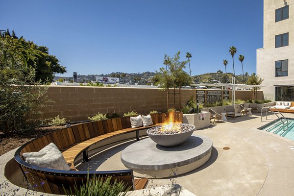 Fire pit lounge area at Rae on Sunset Apartments, luxury community in Los Angeles offering upscale outdoor amenities