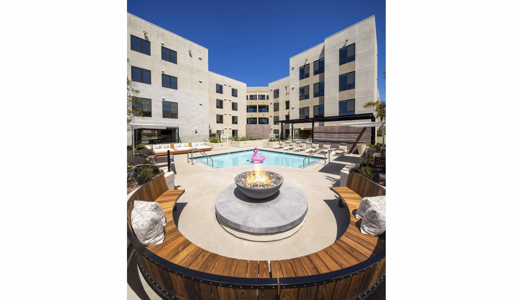 Cozy outdoor fire pit area at Rae on Sunset Apartments, perfect for evenings in luxurious surroundings