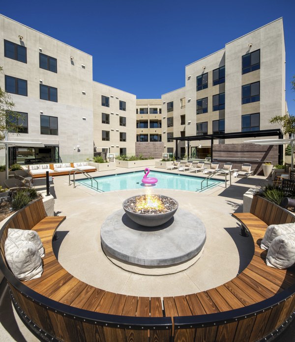 Cozy outdoor fire pit area at Rae on Sunset Apartments, perfect for evenings in luxurious surroundings