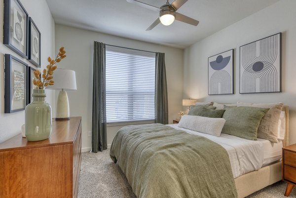 Cozy bedroom featuring modern furnishings and natural light at Tacara Gruene Apartments