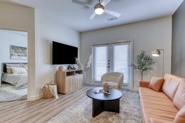 Modern living room with stylish decor and large windows at Tacara Gruene Apartments