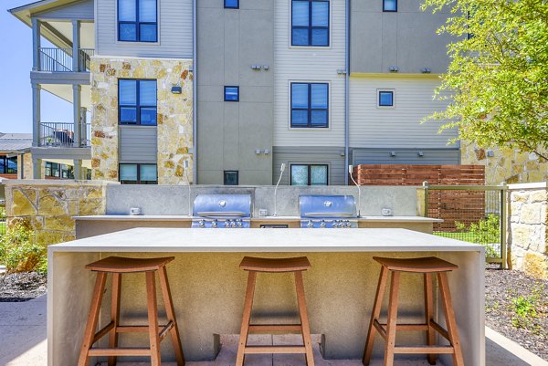 Modern outdoor grill area and patio at Tacara Gruene Apartments, perfect for social gatherings and entertaining