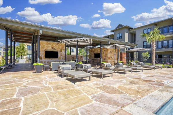 Relaxing pool and spacious patio at Tacara Gruene Apartments, perfect for unwinding and social gatherings