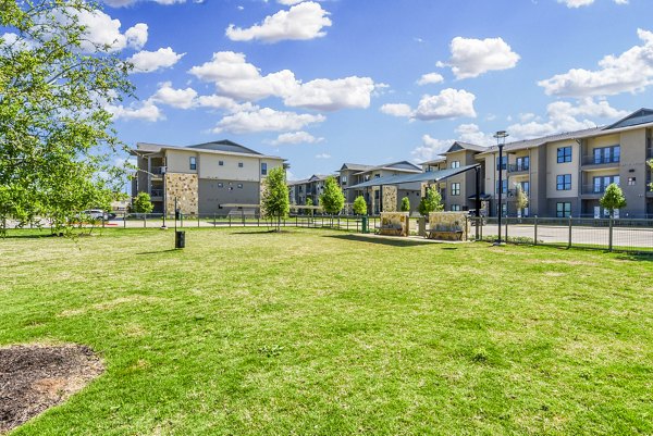 Dog park with agility equipment at Tacara Gruene Apartments, perfect for pet-friendly luxury living