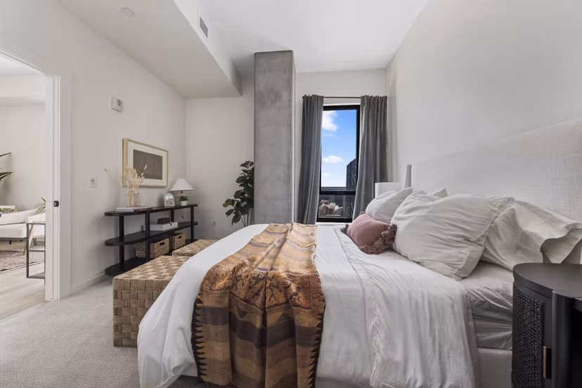 Bedroom with modern decor at Moontower PHX Apartments featuring luxury linens and spacious layout