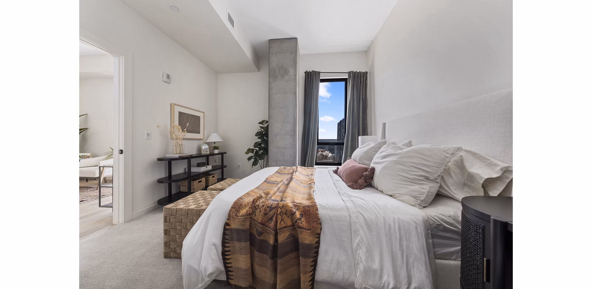 Bedroom with modern decor at Moontower PHX Apartments featuring luxury linens and spacious layout