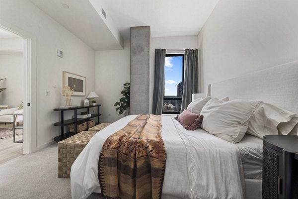 Bedroom with modern decor at Moontower PHX Apartments featuring luxury linens and spacious layout