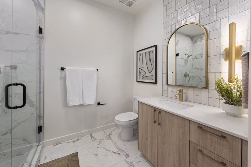 Modern bathroom with sleek fixtures and marble countertop in Moontower PHX Apartments