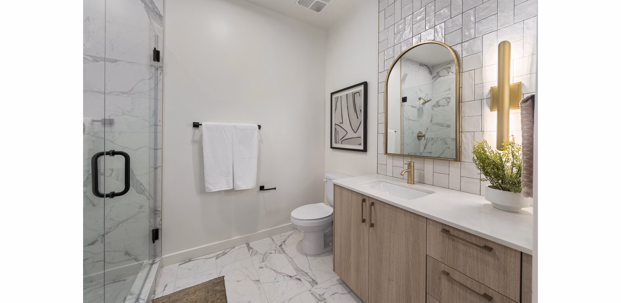 Modern bathroom with sleek fixtures and marble countertop in Moontower PHX Apartments