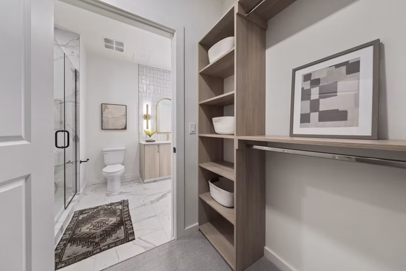 Bright hallway with modern lighting and artwork at Moontower PHX Apartments