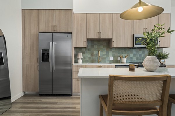 Modern kitchen with stainless steel appliances in Moontower PHX Apartments, luxury living in Phoenix