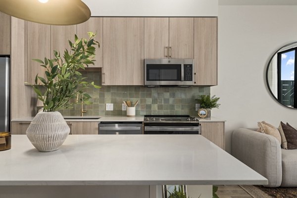 Modern kitchen with stainless steel appliances at Moontower PHX Apartments