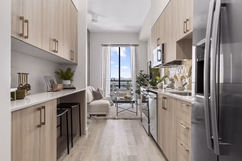 Modern kitchen with stainless steel appliances and granite countertops at Moontower PHX Apartments