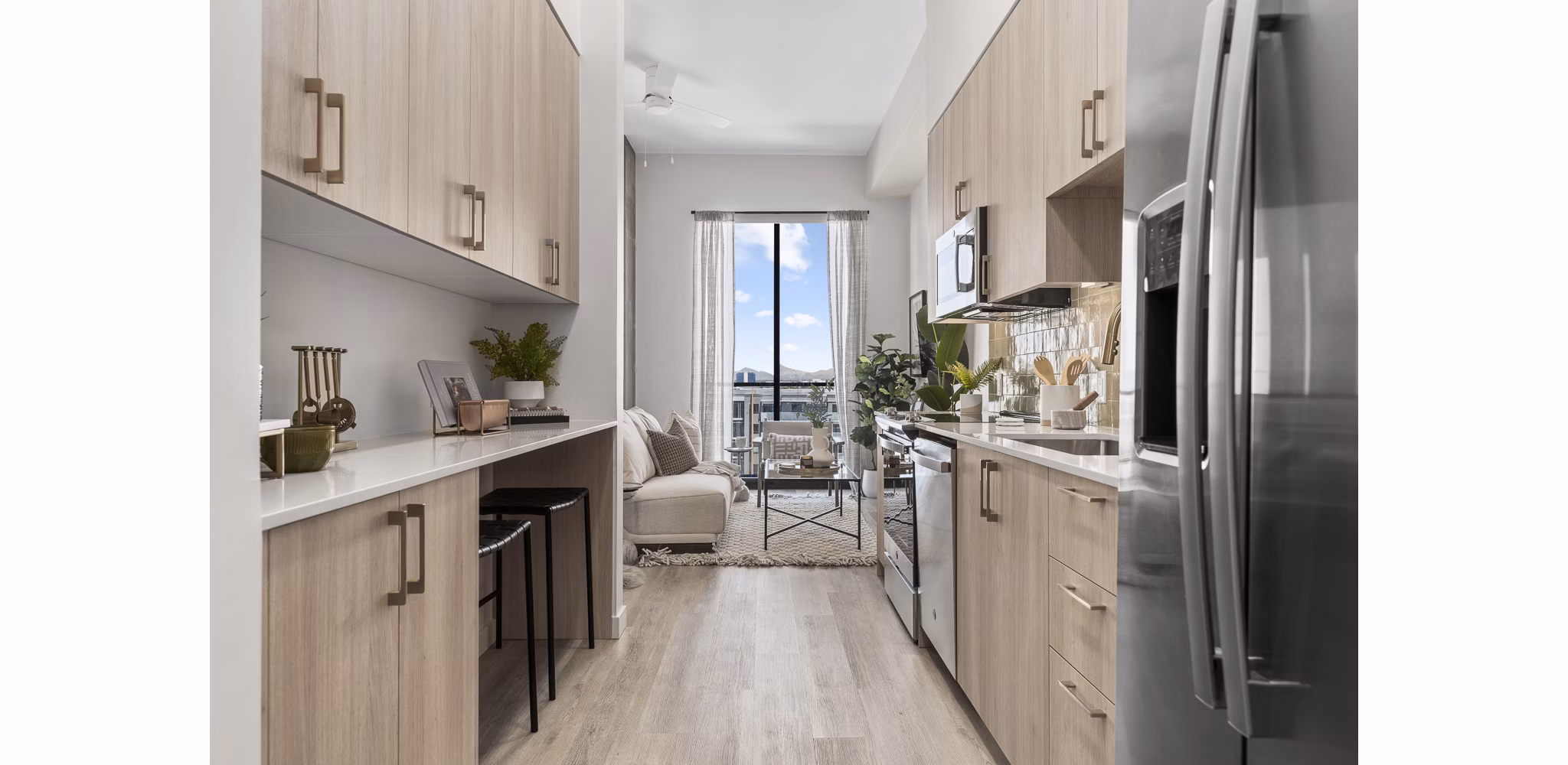 Modern kitchen with stainless steel appliances and granite countertops at Moontower PHX Apartments