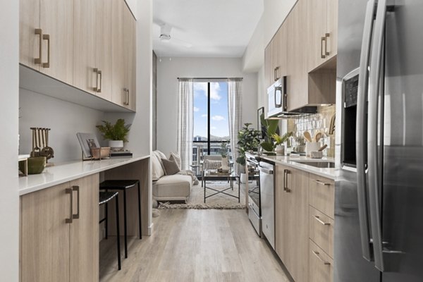 Modern kitchen with stainless steel appliances and granite countertops at Moontower PHX Apartments