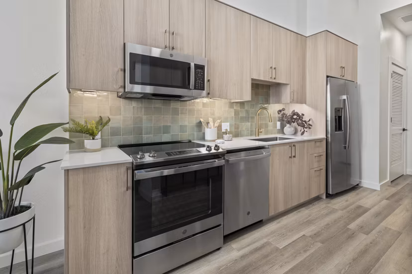 Modern kitchen featuring stainless steel appliances and granite countertops in Moontower PHX Apartments