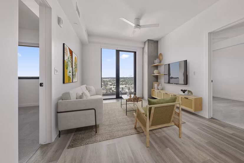 Elegant living room with modern decor and large windows at Moontower PHX Apartments, offering luxury living in the heart of the city