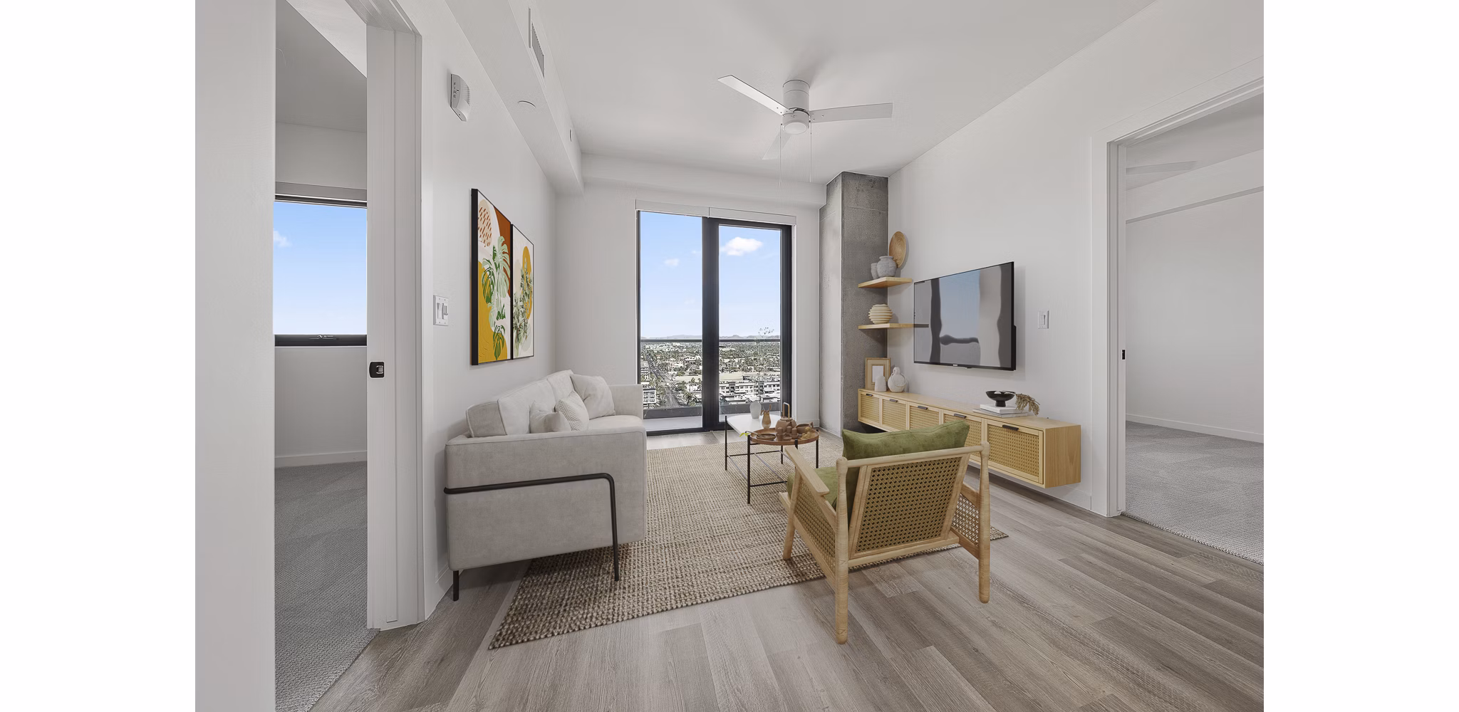 Elegant living room with modern decor and large windows at Moontower PHX Apartments, offering luxury living in the heart of the city