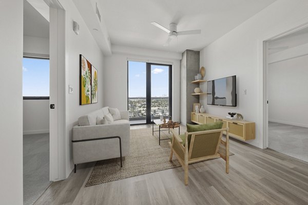 Elegant living room with modern decor and large windows at Moontower PHX Apartments, offering luxury living in the heart of the city