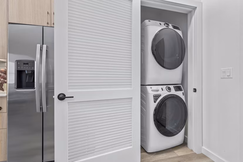 Modern laundry room with high-efficiency washers and dryers at Moontower PHX Apartments