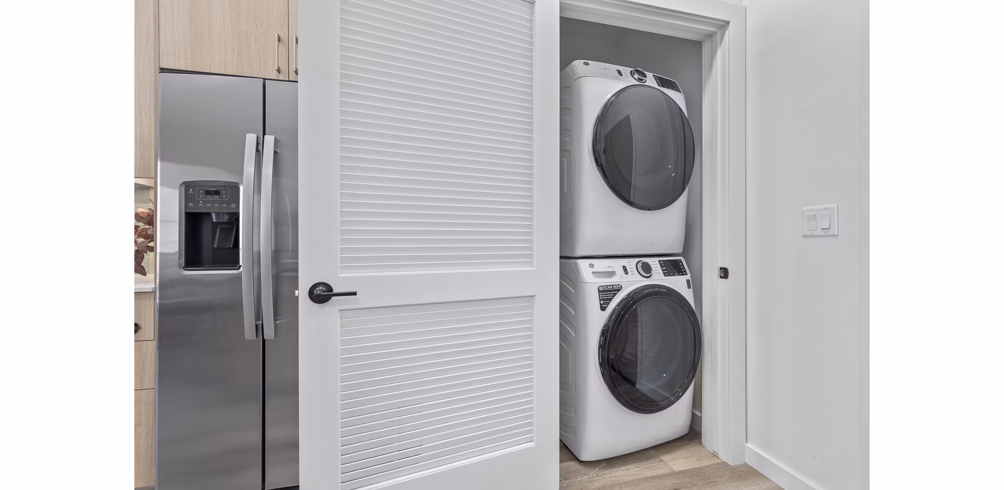 Modern laundry room with high-efficiency washers and dryers at Moontower PHX Apartments