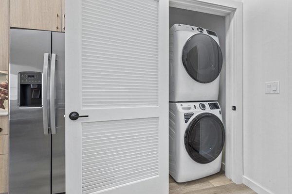 Modern laundry room with high-efficiency washers and dryers at Moontower PHX Apartments