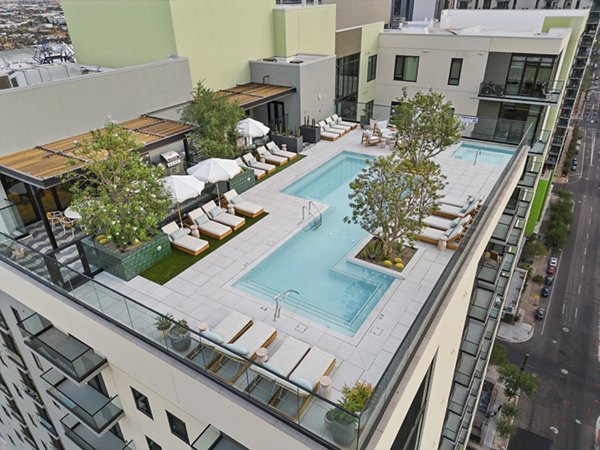 Relaxing pool with sun loungers at Moontower PHX Apartments, luxurious outdoor amenity for residents' enjoyment