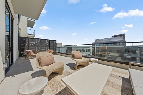 Outdoor patio with stylish seating and modern lighting at Moontower PHX Apartments