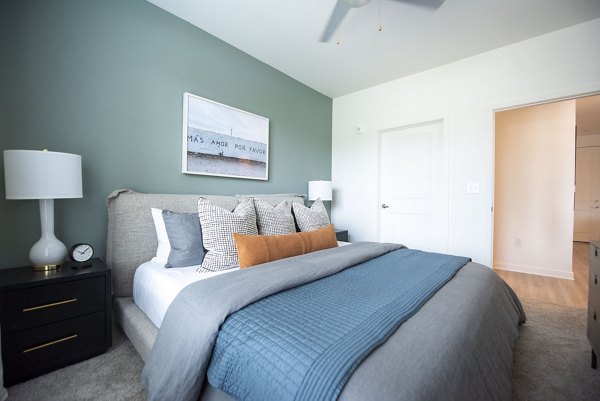 Bedroom featuring elegant decor and large windows at The Whitby luxury apartments