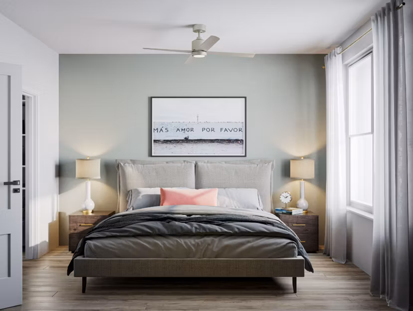 Cozy bedroom featuring modern decor and large windows in The Whitby luxury apartments