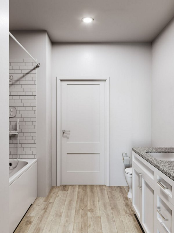 Modern bathroom with sleek marble countertops and chrome fixtures in The Whitby luxury apartments