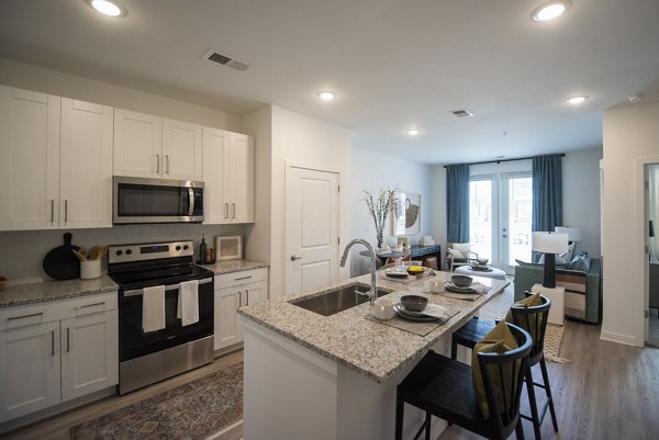 Modern kitchen with stainless steel appliances at The Whitby luxury apartments
