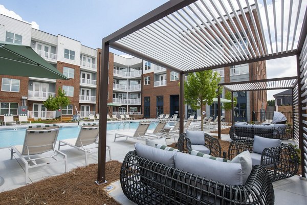 Luxurious pool area at The Whitby Apartments offering serene outdoor lounging spaces