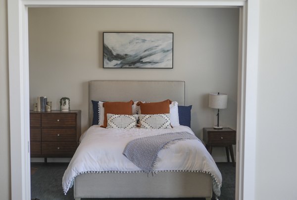 Cozy bedroom with modern decor at 888 4th Street Apartments, showcasing luxury living in a prime urban location