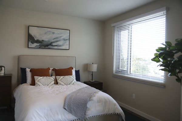 Bedroom with modern decor featuring plush bedding at 888 4th Street Apartments